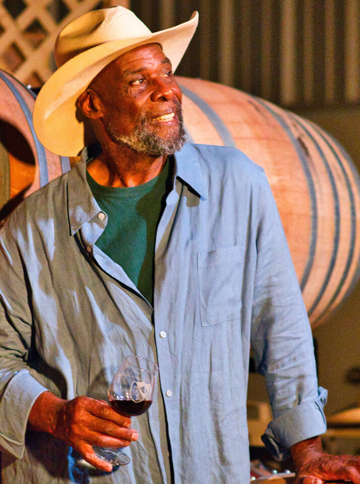 Al Dotson holding wine glass and looking out to towards the sky